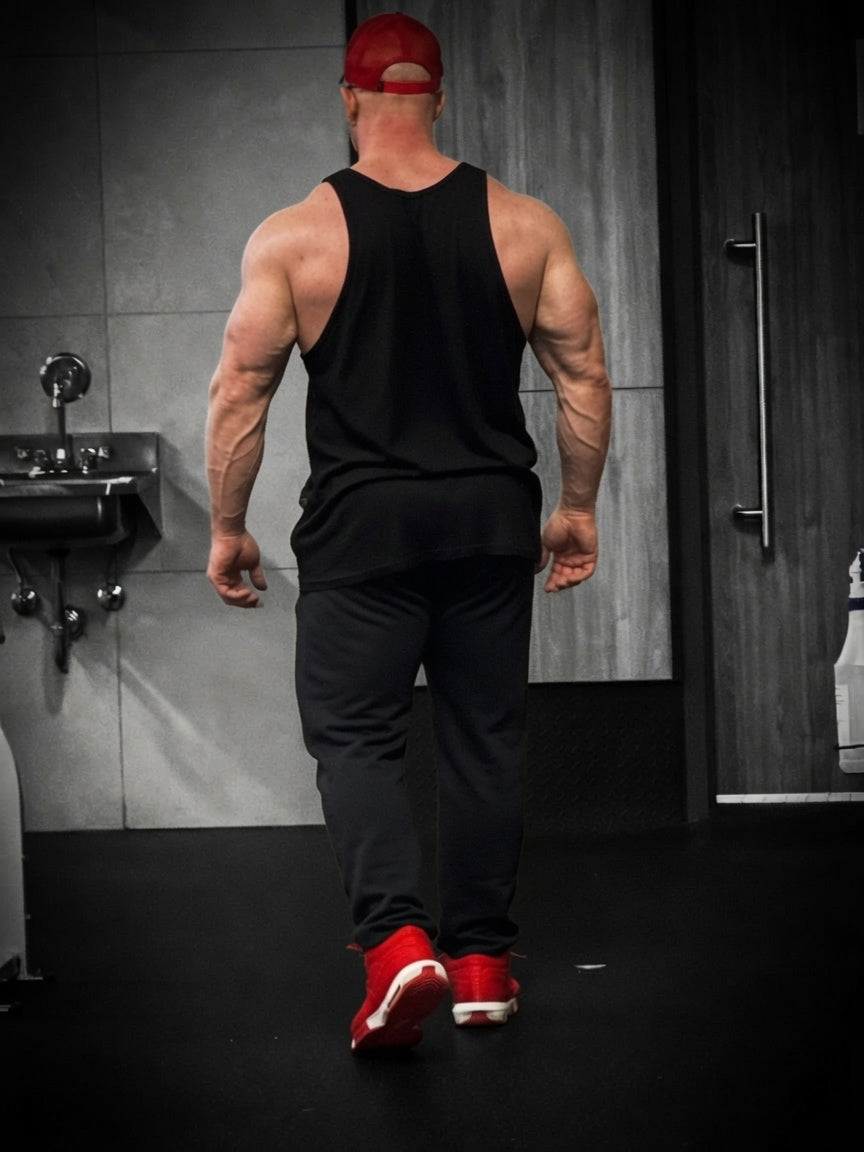 A lifter pressed back into a PR Grip mat on a bench