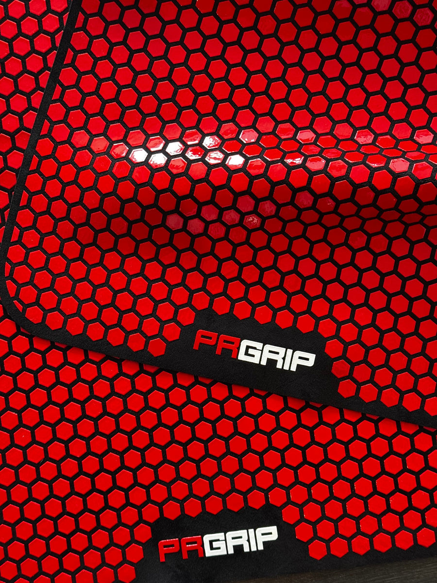 Close-up of the red HexaTrac grip pattern on a PR Grip mat